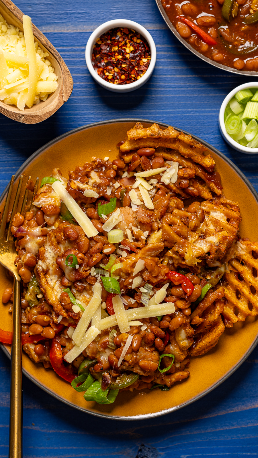 Photo of plate of food on a blue wood table.