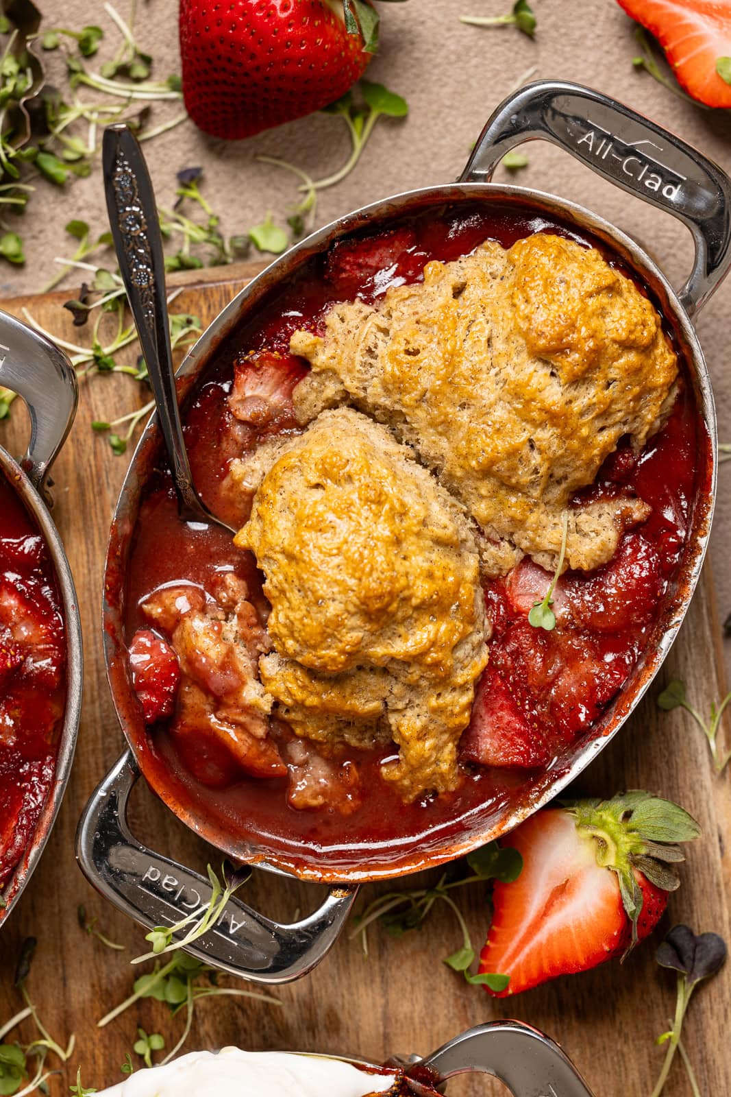 Photo of strawberry cobbler with strawberries.